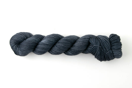 Navy blue skein of tonal yarn.