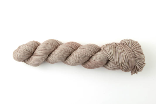 A skein of tan tonal yarn.