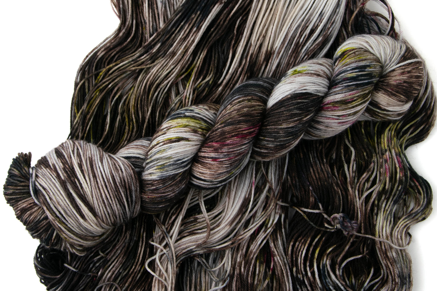 A skein of Granite yarn on a pile of it laid out across the frame.