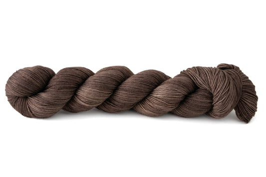 A skein of rich brown hand-dyed wool yarn.