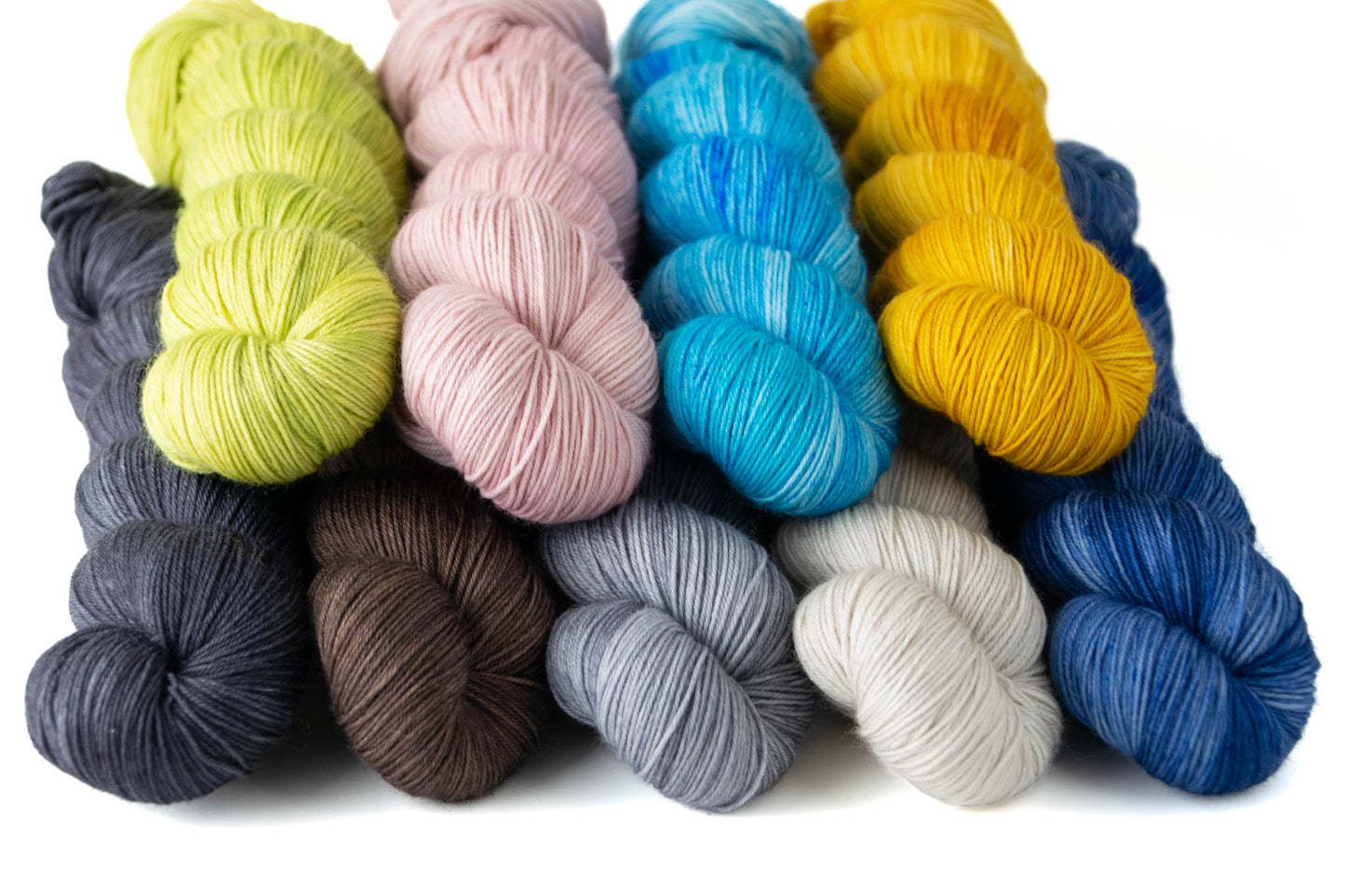 One skein of each of the Pyrex colors: Verde, Friendship, Blue Doily, Town and Country, Pueblo, Old Orchard, Homestead, Stoneware, and Midnight Bloom.