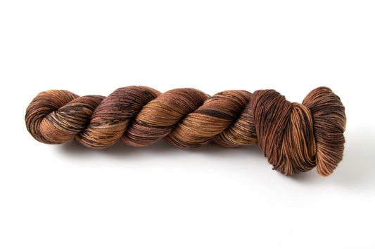 A variegated skein of browns from rich dark to light orange-brown, designed to look like wood paneling.