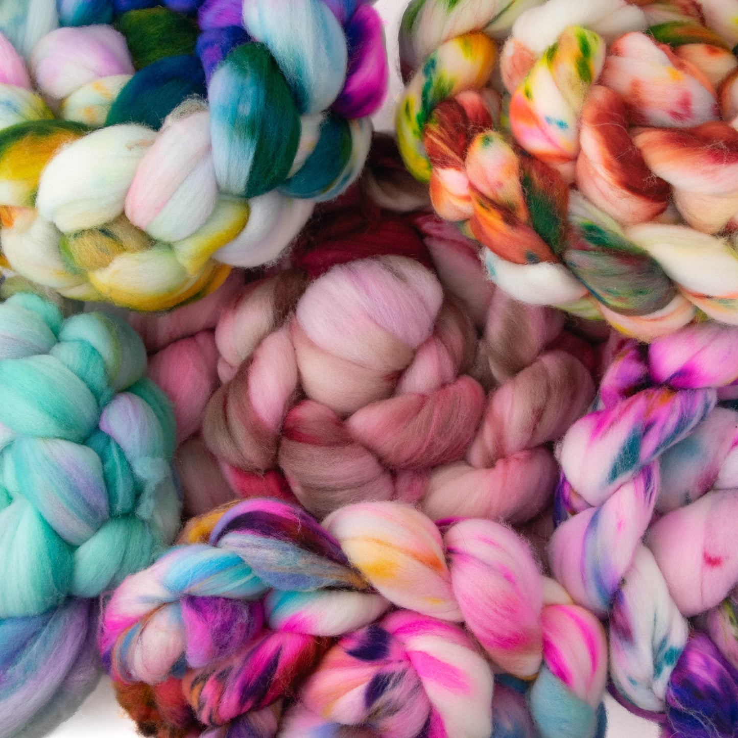 The six variegated colorways on fiber stacked up together.