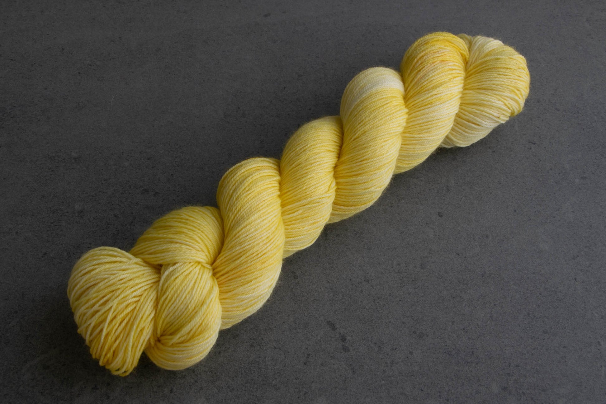 A skein of cheery yellow hand-dyed yarn.