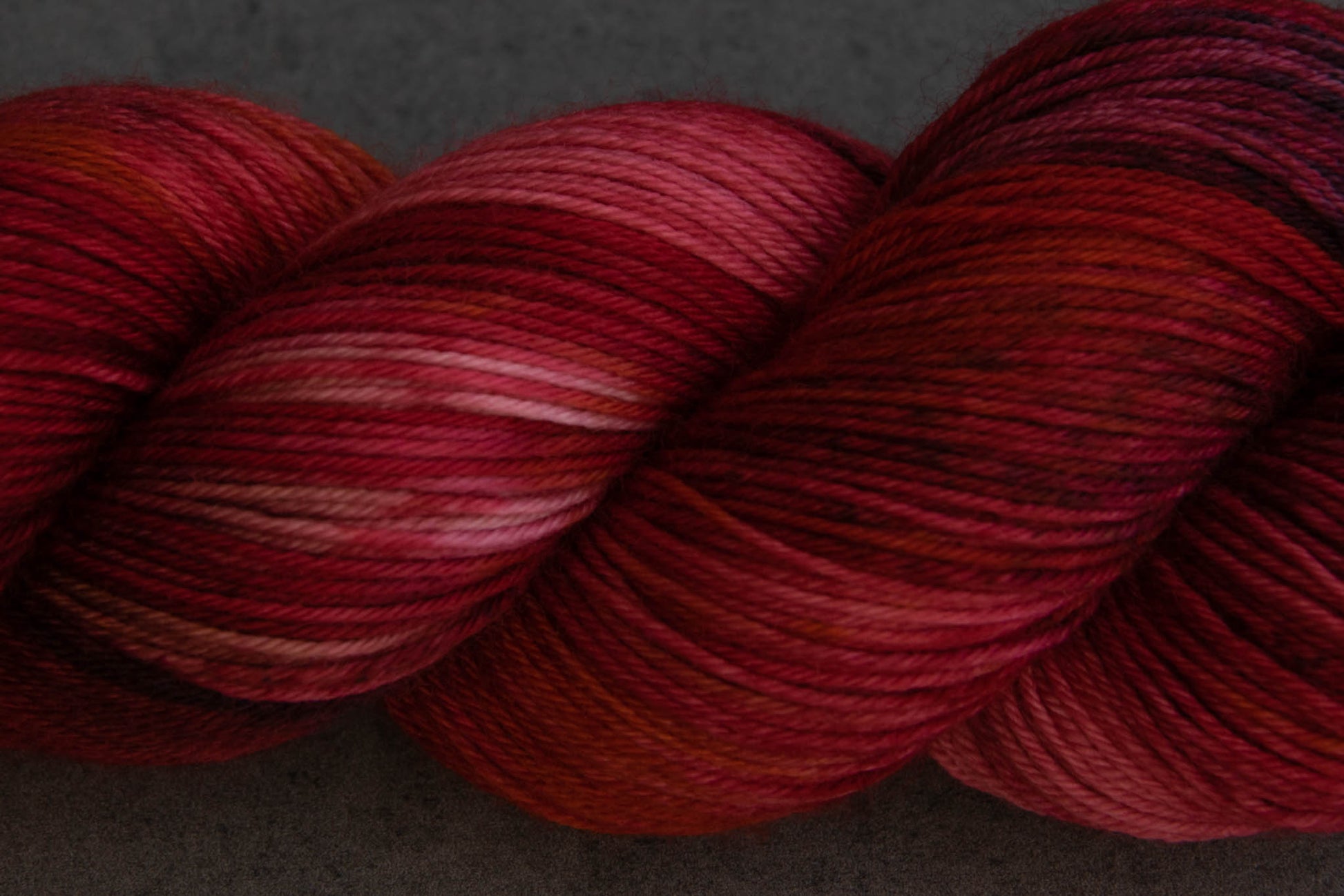 Closeup of the variegation, including sections of red, pink, and plum.