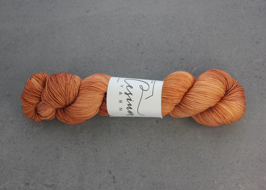 A skein of tonal orange yarn.