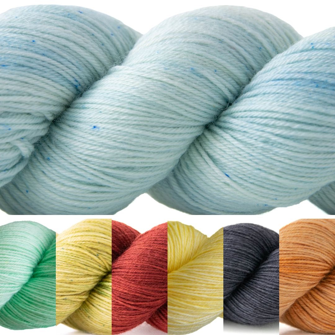 A large blue skein with small microspeckles above six small skeins in aqua, green, red, yellow, gray, and orange.