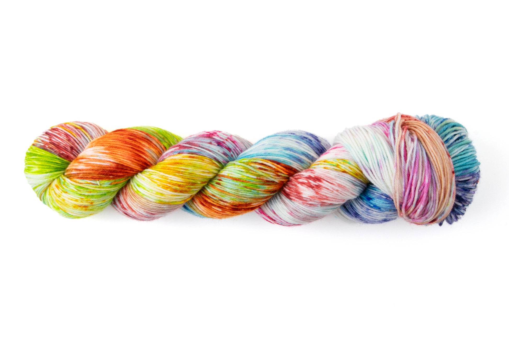 A bright rainbow skein of yarn with a white background.