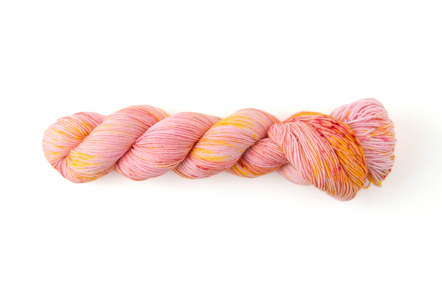 A skein of yarn with a pink base and orange and pink speckles.