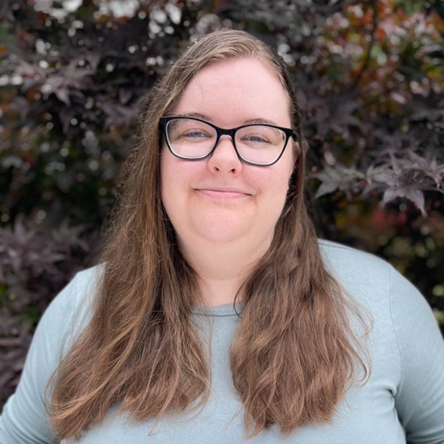 Penny, a white woman with brown hair and glasses.