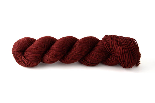 A skein of deep wine-colored yarn.