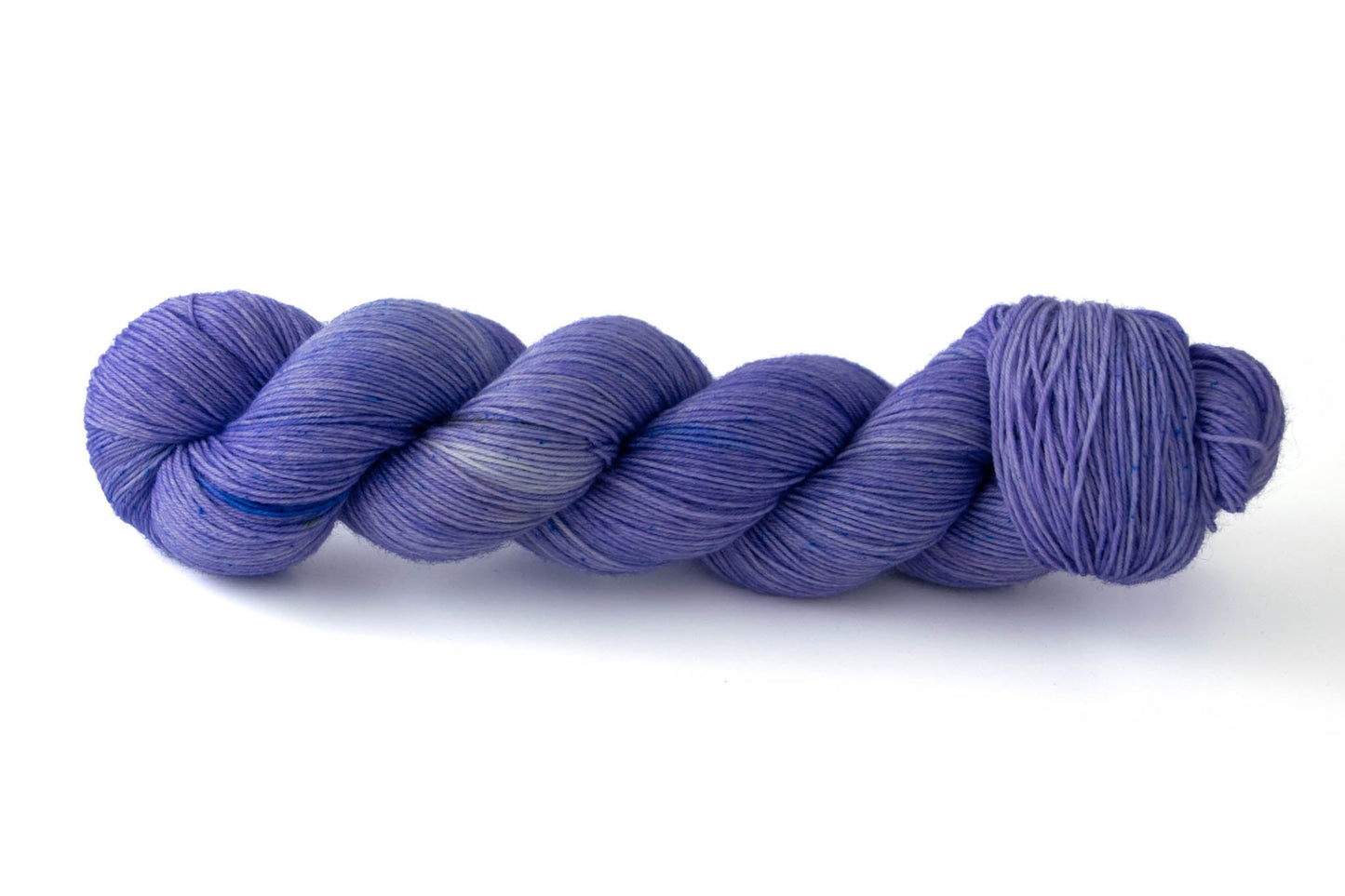 A skein of neon lilac hand-dyed wool yarn.