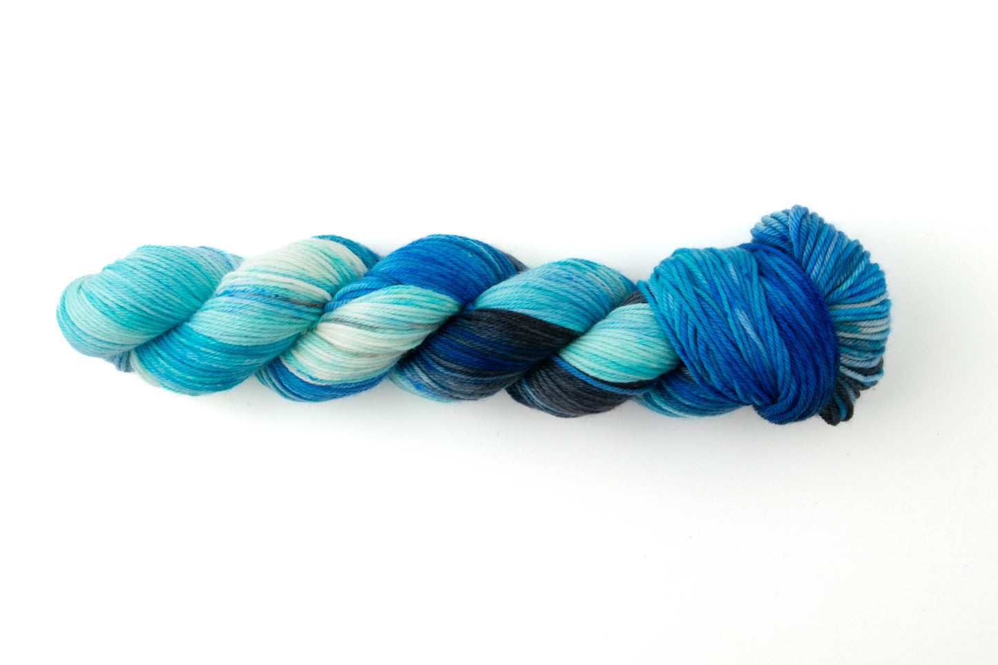 A skein of blue yarn with highly variegated texture.