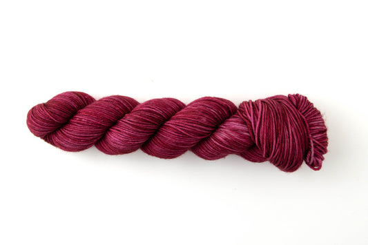 Wine red skein of tonal yarn.