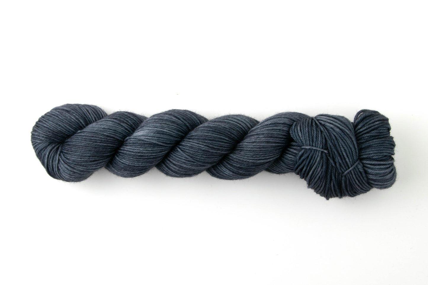 Navy blue skein of tonal yarn.