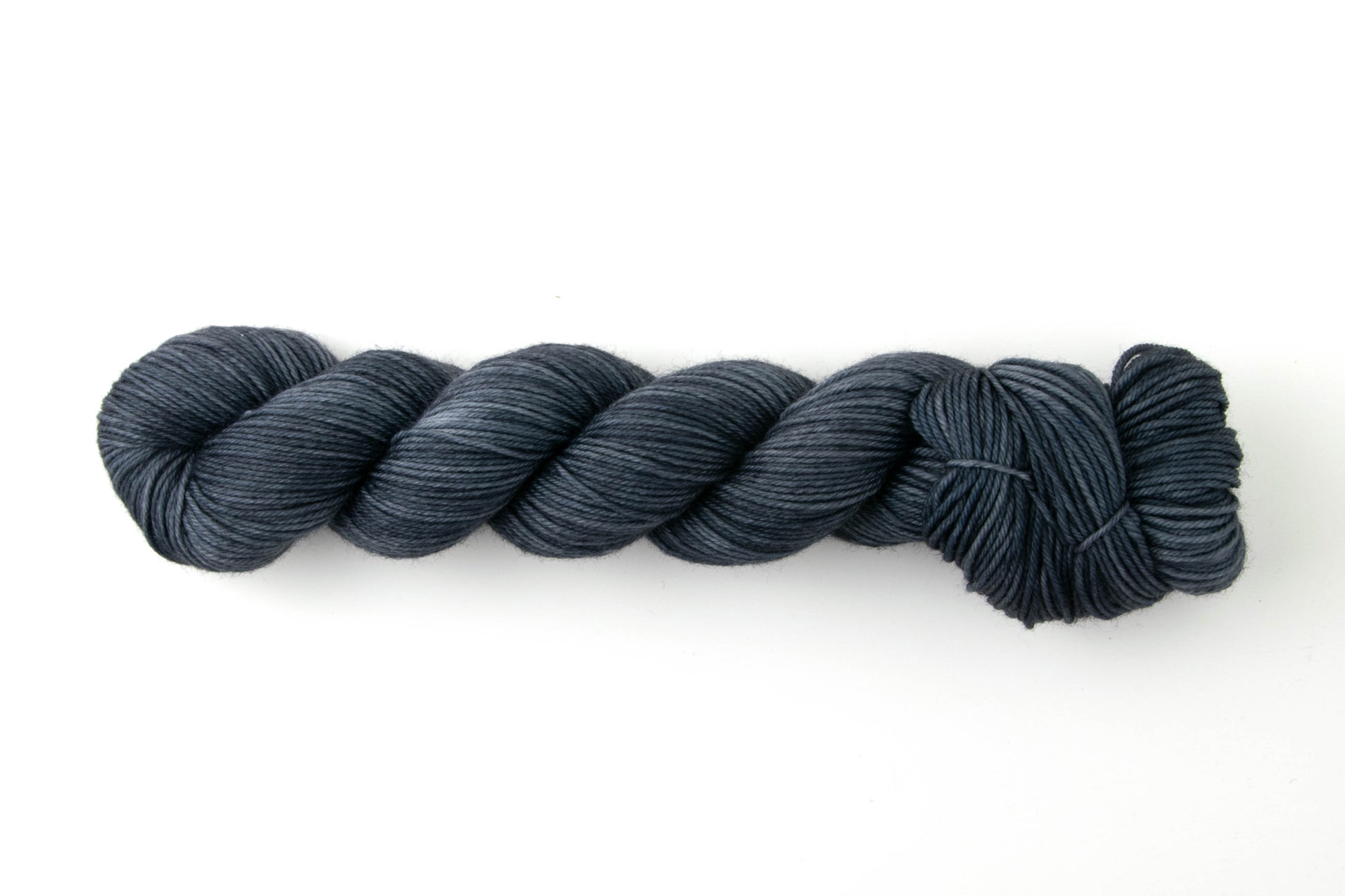 Navy blue skein of tonal yarn.