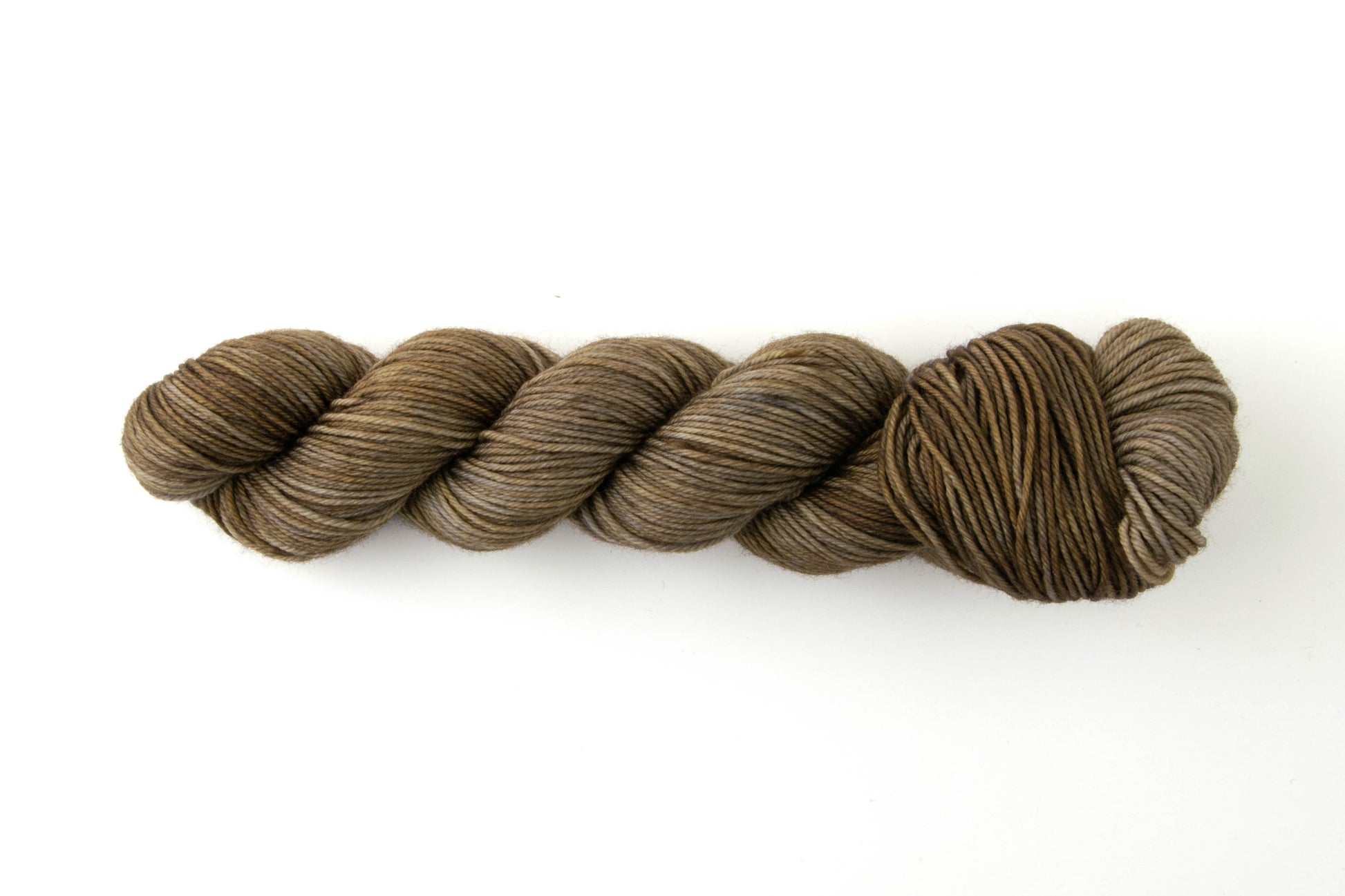 A green-toned brown tonal skein of yarn.
