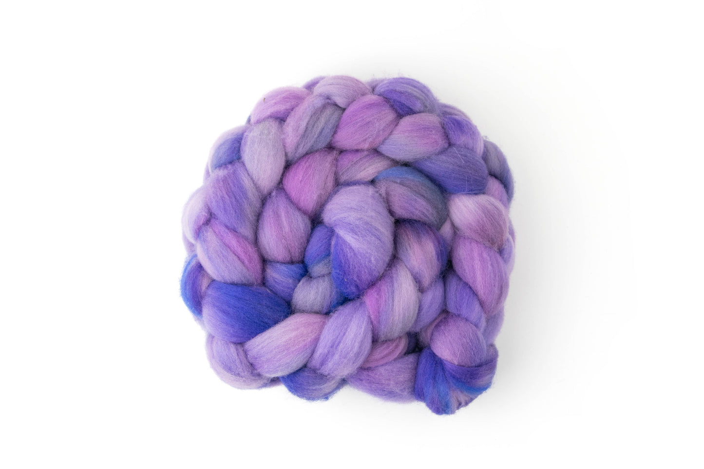 A braid of nonsuperwash fiber in watercolor-like purples, leaning from blue to pink.