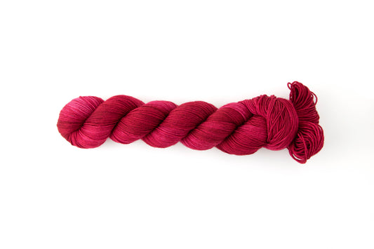 A bright saturated red skein of yarn.