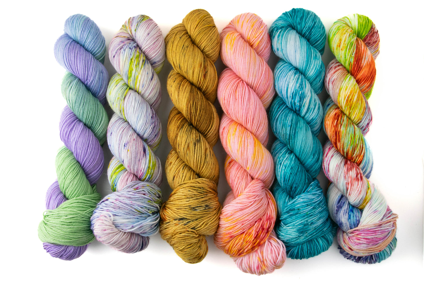 The variegates in the Dragon Tales collection, including green and blue, green and purple, brown, pink, blue, and rainbow colorways.