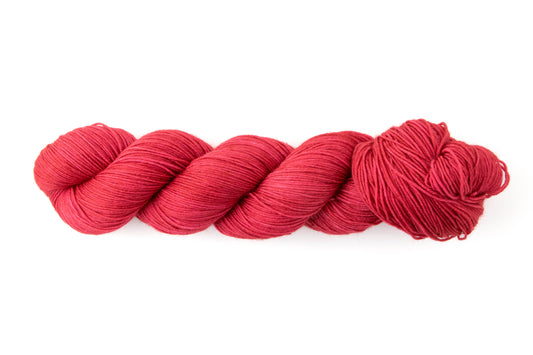 A bright primary red skein of yarn.