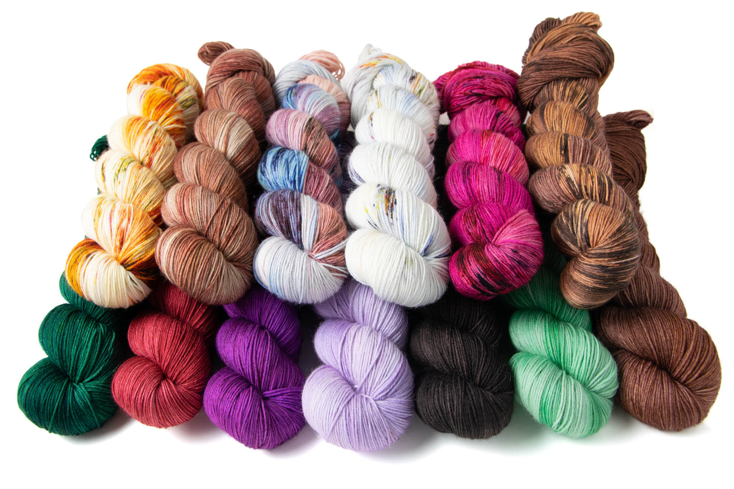  A stack of the thirteen colorways in the Cabin Collection: Craft Nook, Fireplace, Games Cabinet, Marbles, Fuchsia Flowers, Cabin Walls, Carpet, Comfy Cozy Couches, Purple Underpants, Creator of Beauty, Fixtures, Grandma's Pert, and Penny Pinecones.