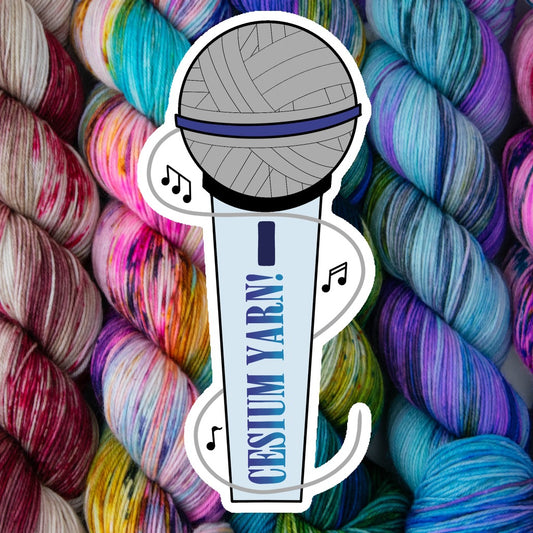 An illustration of a microphone where the head of the mic is a ball of yarn and the handle is labeled with Cesium Yarn in the same style as the Mamma Mia movie title. Laid over a background of yarn. 
