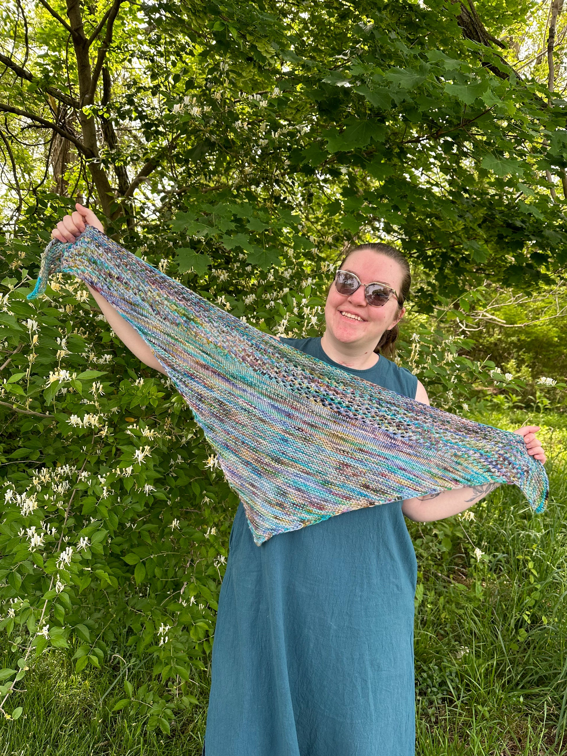 Cat stretches the Gradual Beginner Shawl out, showing its approximately 4-foot wingspan.