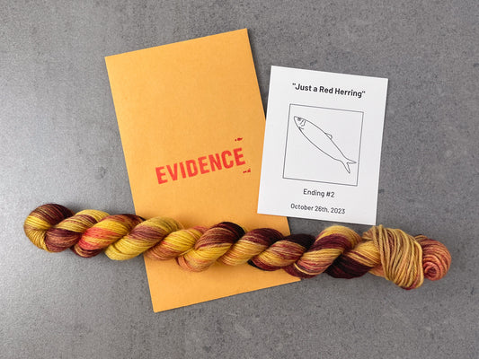 A skein of red and yellow variegated yarn on top of an envelope stamped with "Evidence" and a card with a drawing of a fish on it.