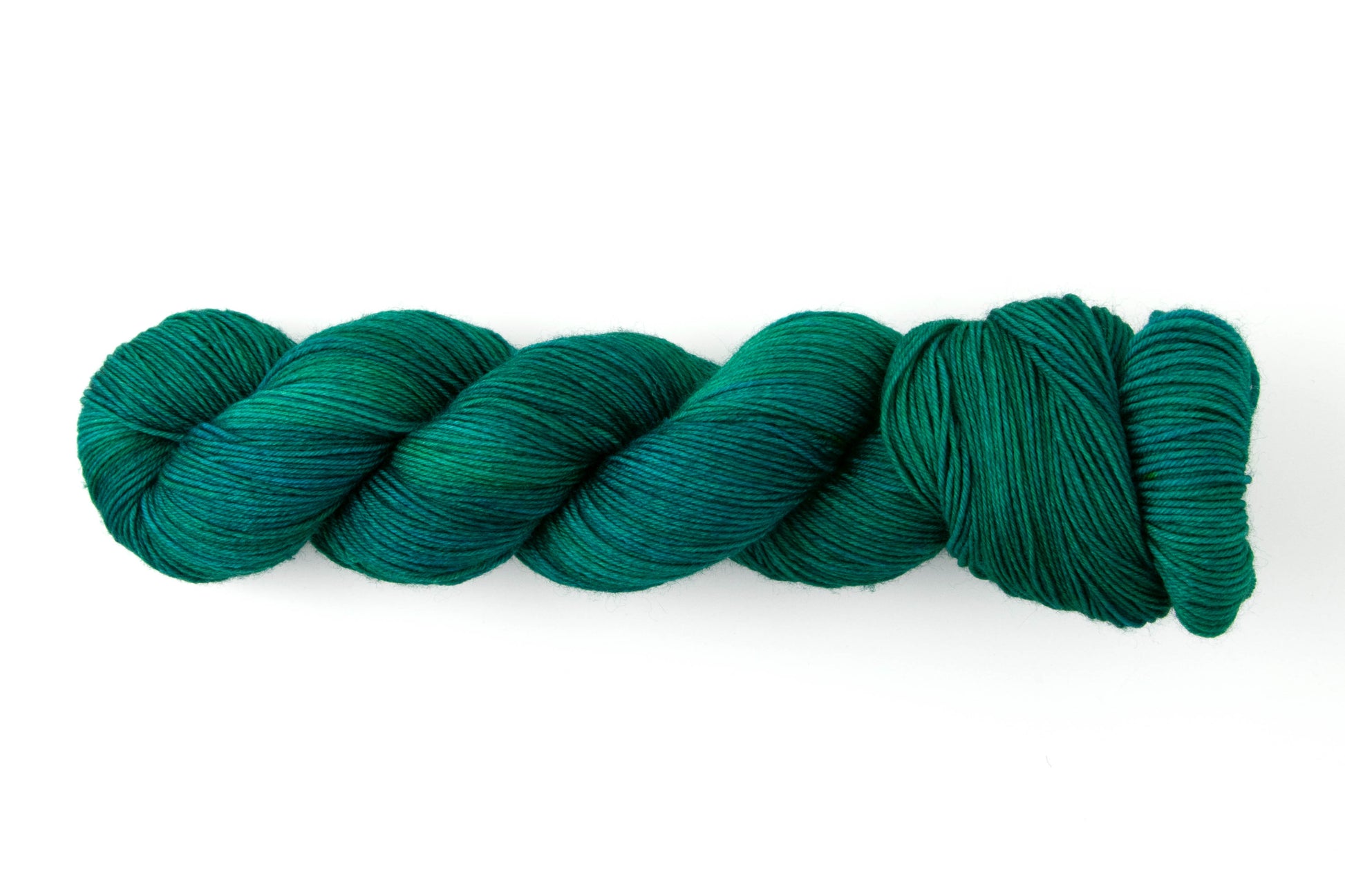 A skein of yarn that transitions between blue and green.