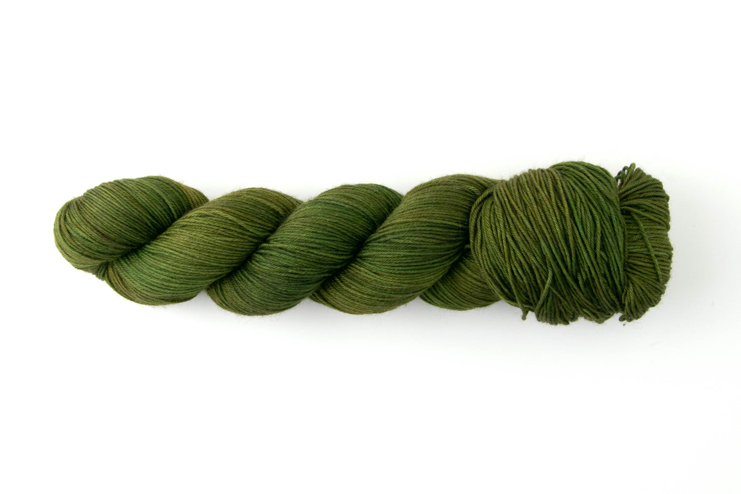 A skein of olive green tonal yarn.