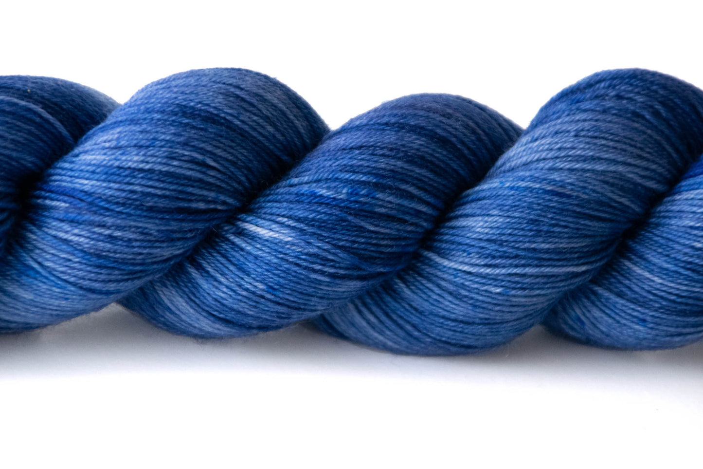 Closeup on the tonal qualities of Midnight Bloom, which ranges from lighter gray-undertone blue to dark navy, and is skewed more towards dark blue.