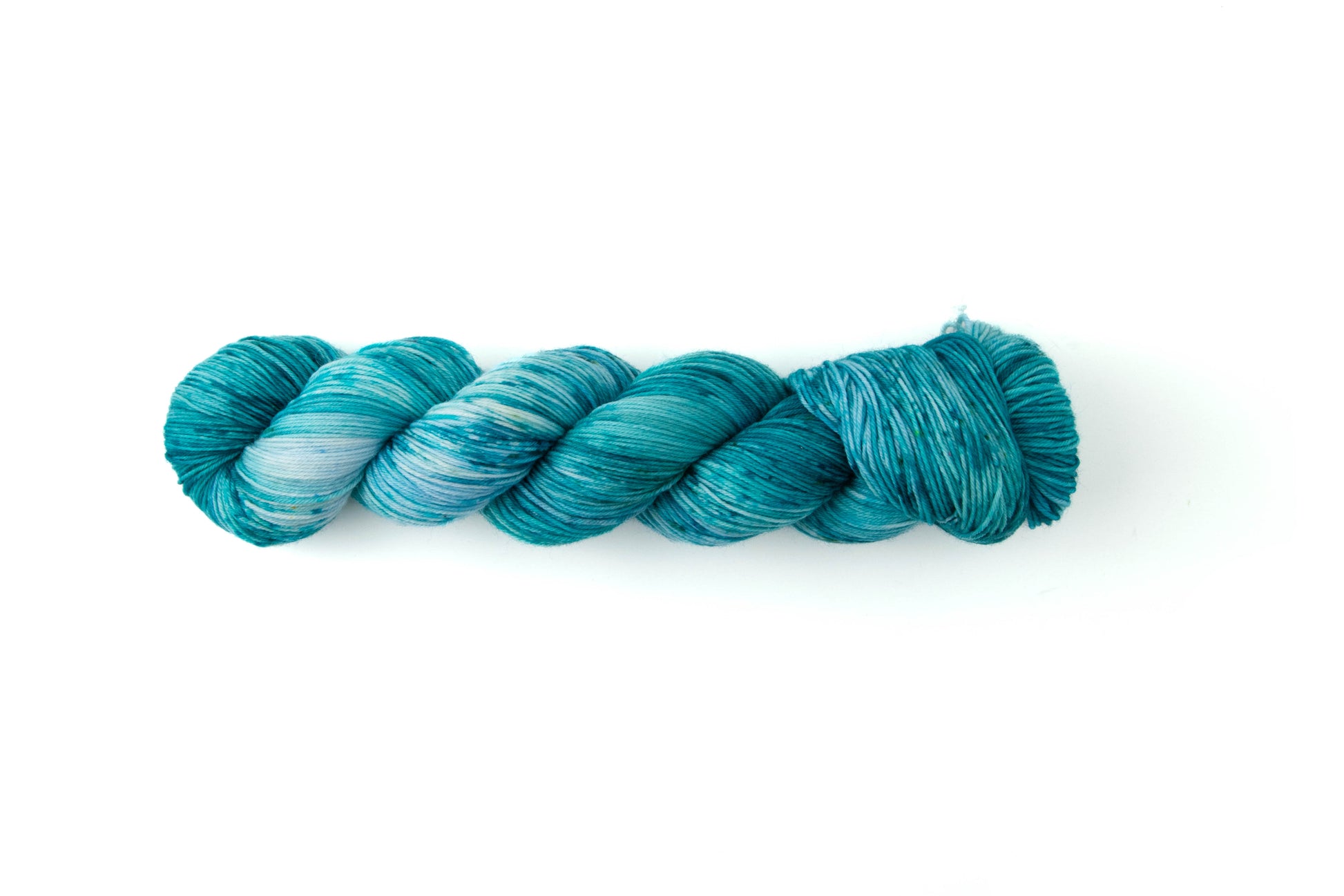 A skein of aqua and blue yarn with darker aqua speckles.