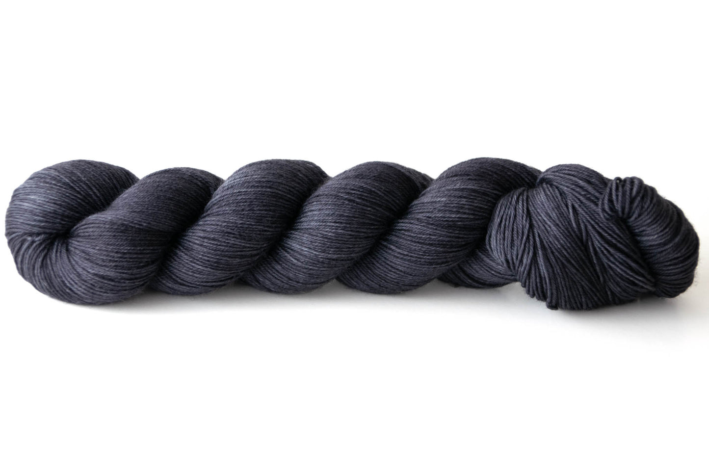 A skein of almost black hand-dyed wool yarn.