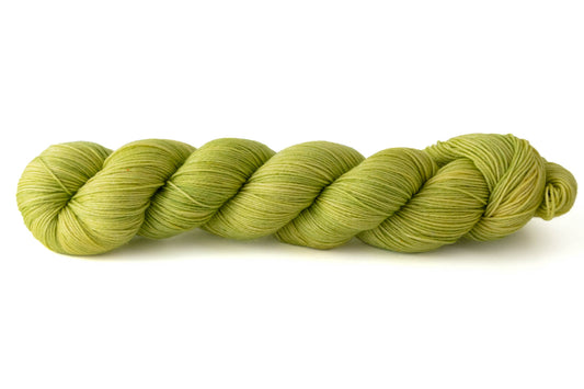 A skein of electric tonal hand-dyed yarn in an almost green, almost yellow chartreuse.