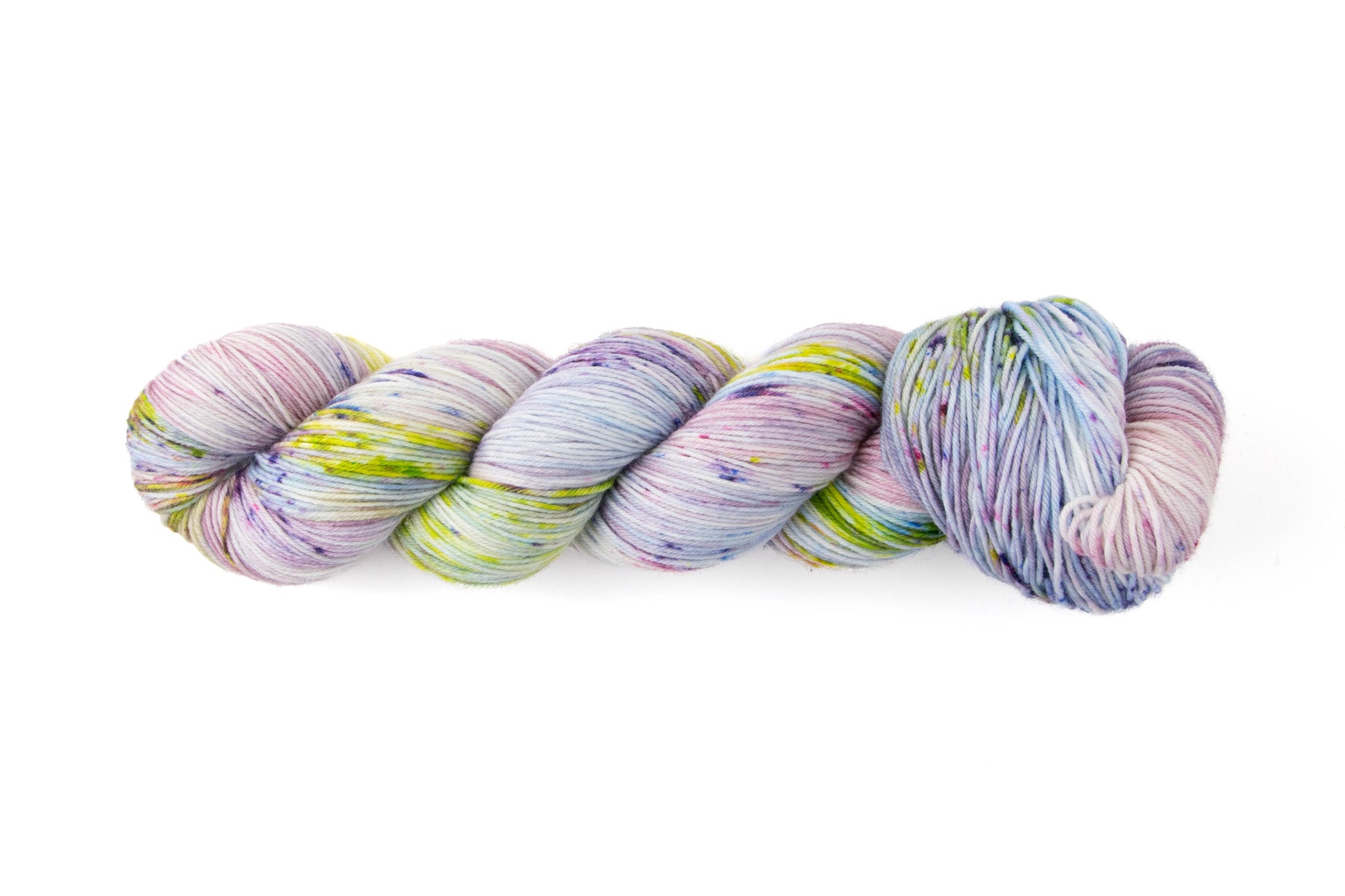 A skein of yarn with pink, purple, green, and blue speckles on an almost-gray white background.