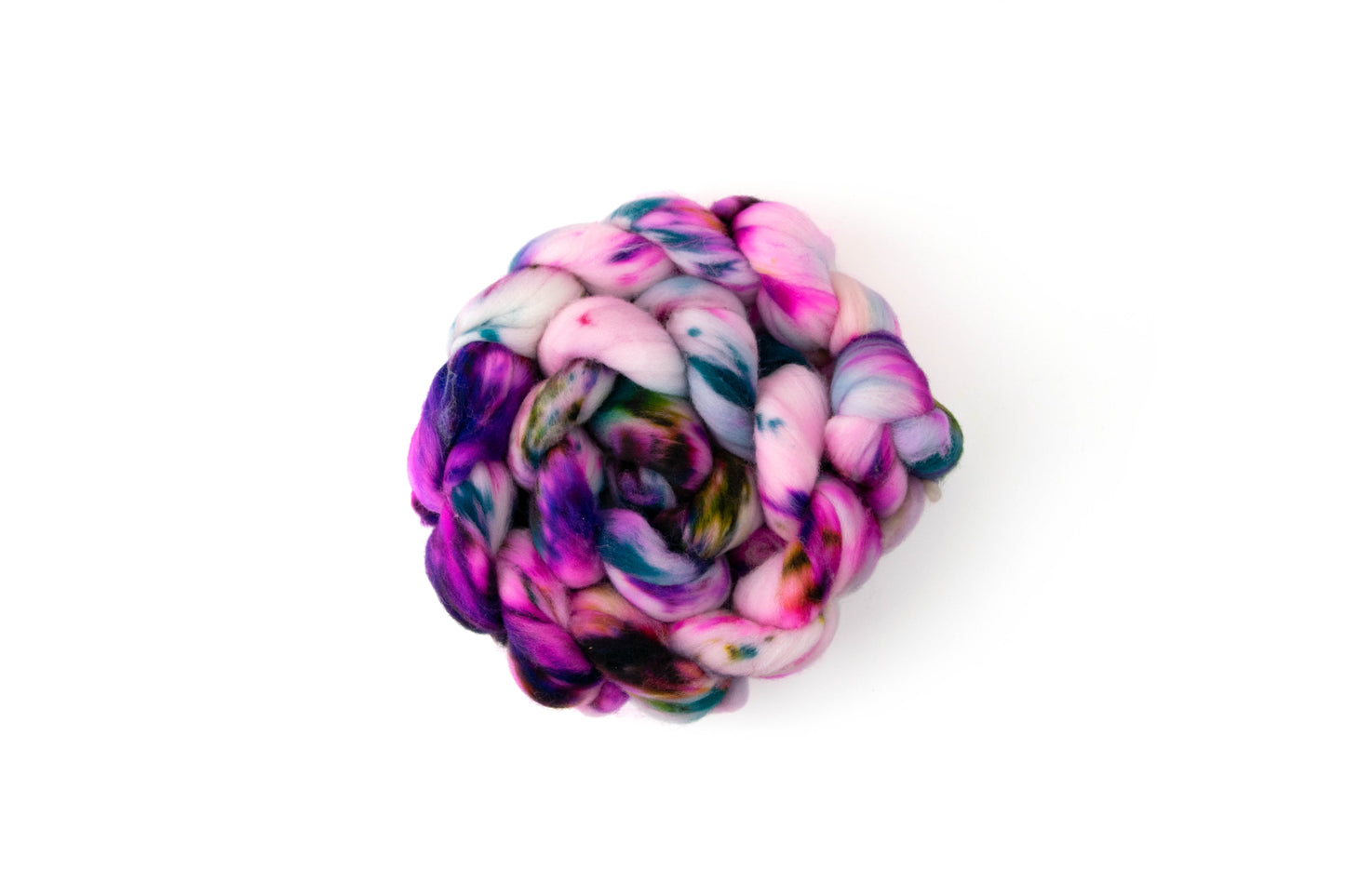 A braid of fiber with pink, purple, blue, and green sections.