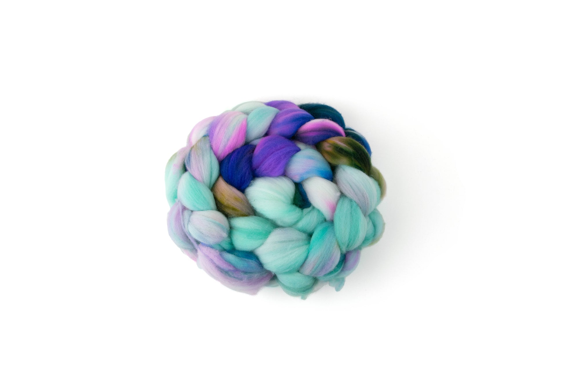 A braid of fluffy spinning fiber wrapped into a circle with sections of aqua, navy, green, purple, and a bit of brown.