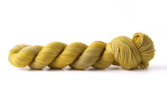 A skein of tonal yellow yarn leaning towards the cool side of the color.