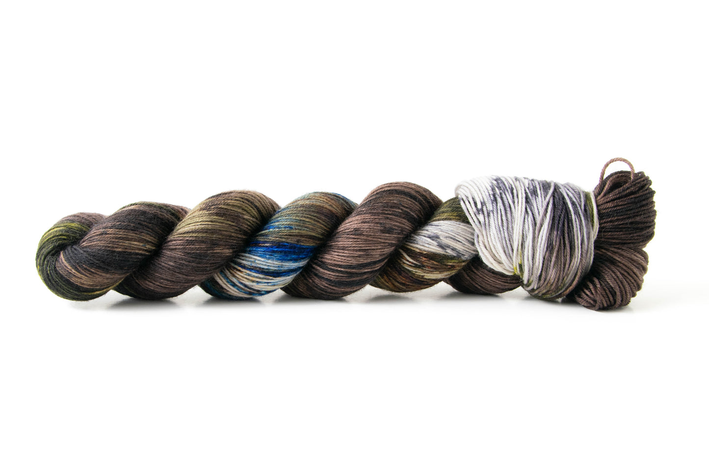 A skein of brown yarn with sections of green, blue, gray, and tan.