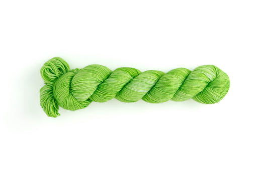 A skein of bright green wool yarn.