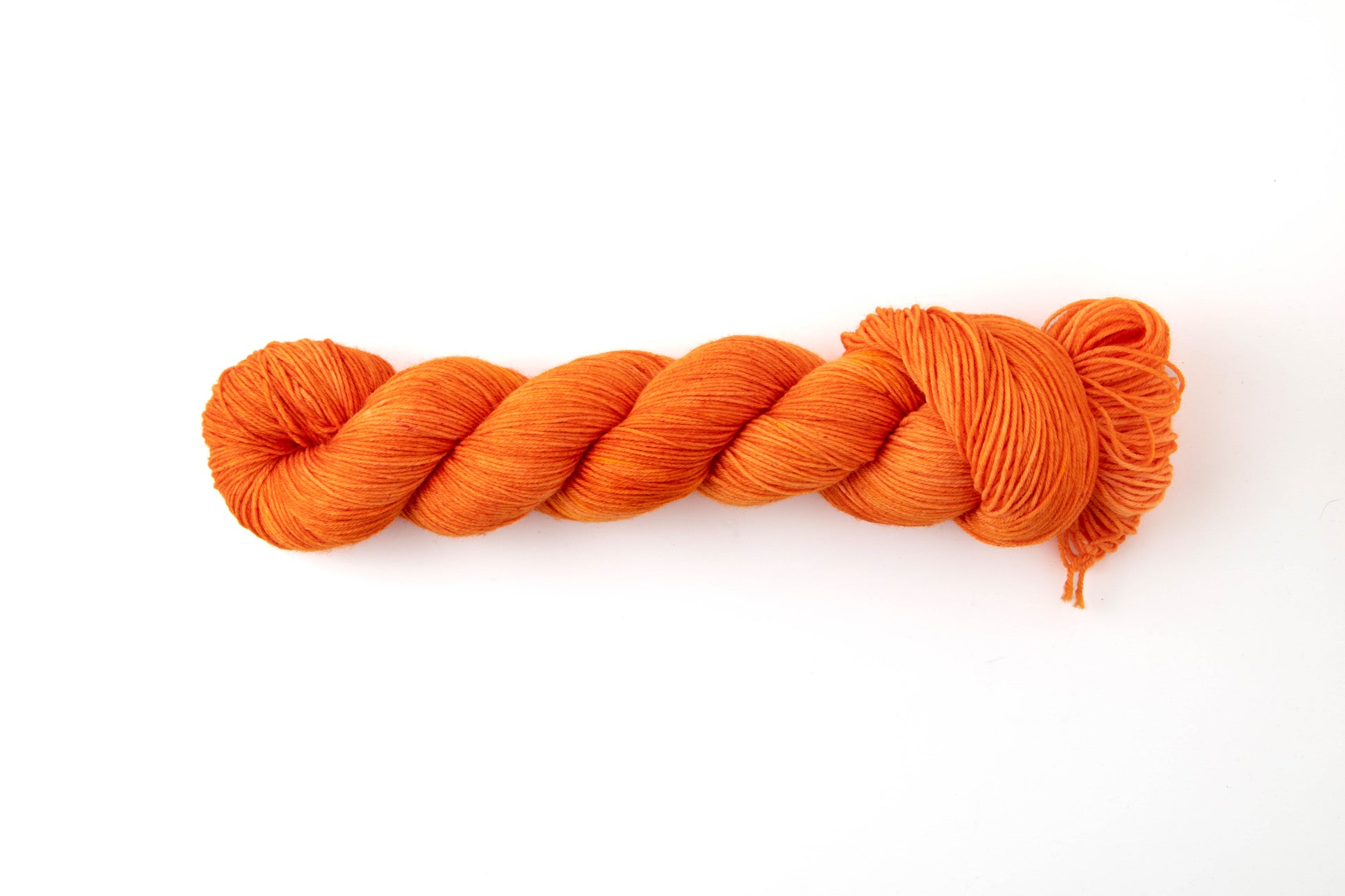 A skein of intense neon orange yarn.