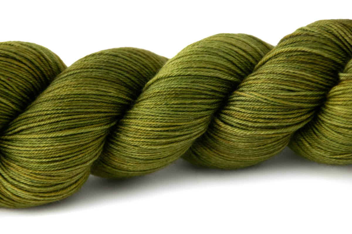 A closeup on the tonal nature of the yarn, with patches of true green, yellow-green, and darker green.