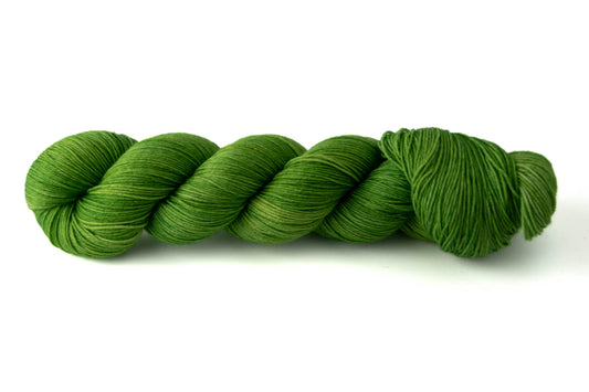 A saturated Granny-Smith green skein of tonal wool yarn.