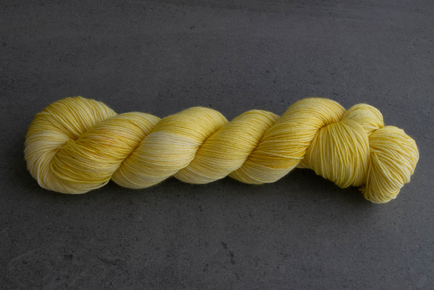 A skein of cheery yellow hand-dyed yarn.