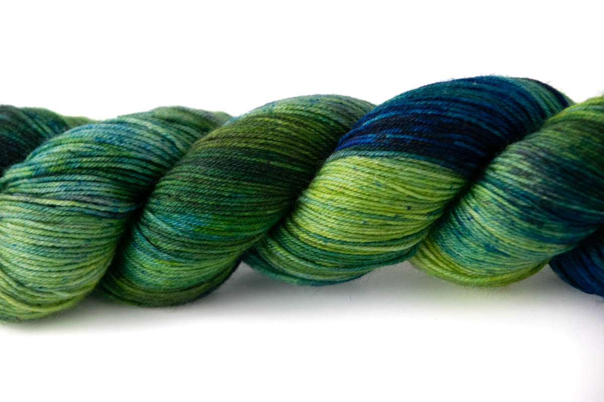 A close view of the variegated texture with patches of dark green, light green, dark navy, and aqua.
