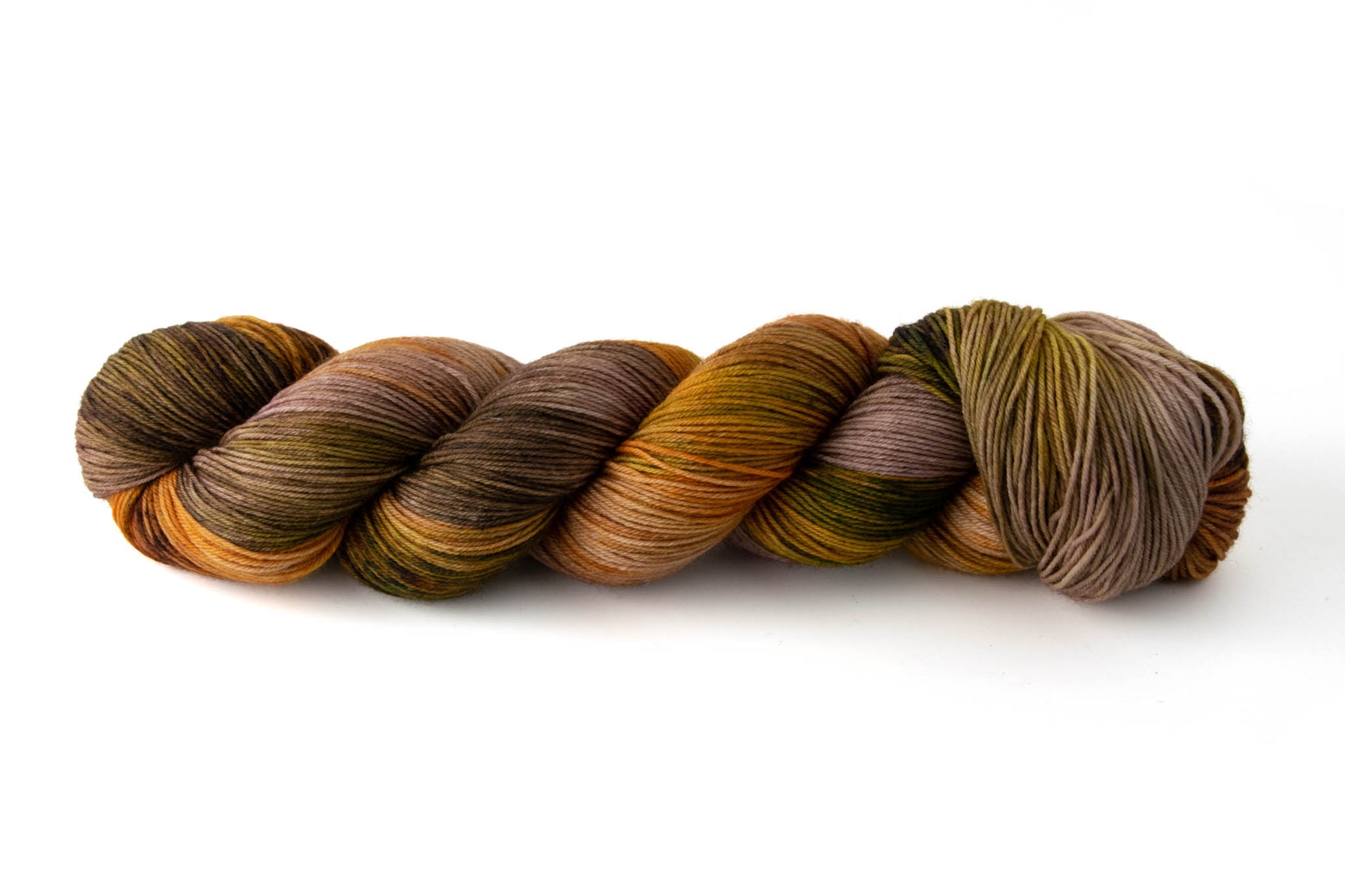 A skein of chocolate brown, rusty orange, and olive green variegated hand-dyed wool yarn.