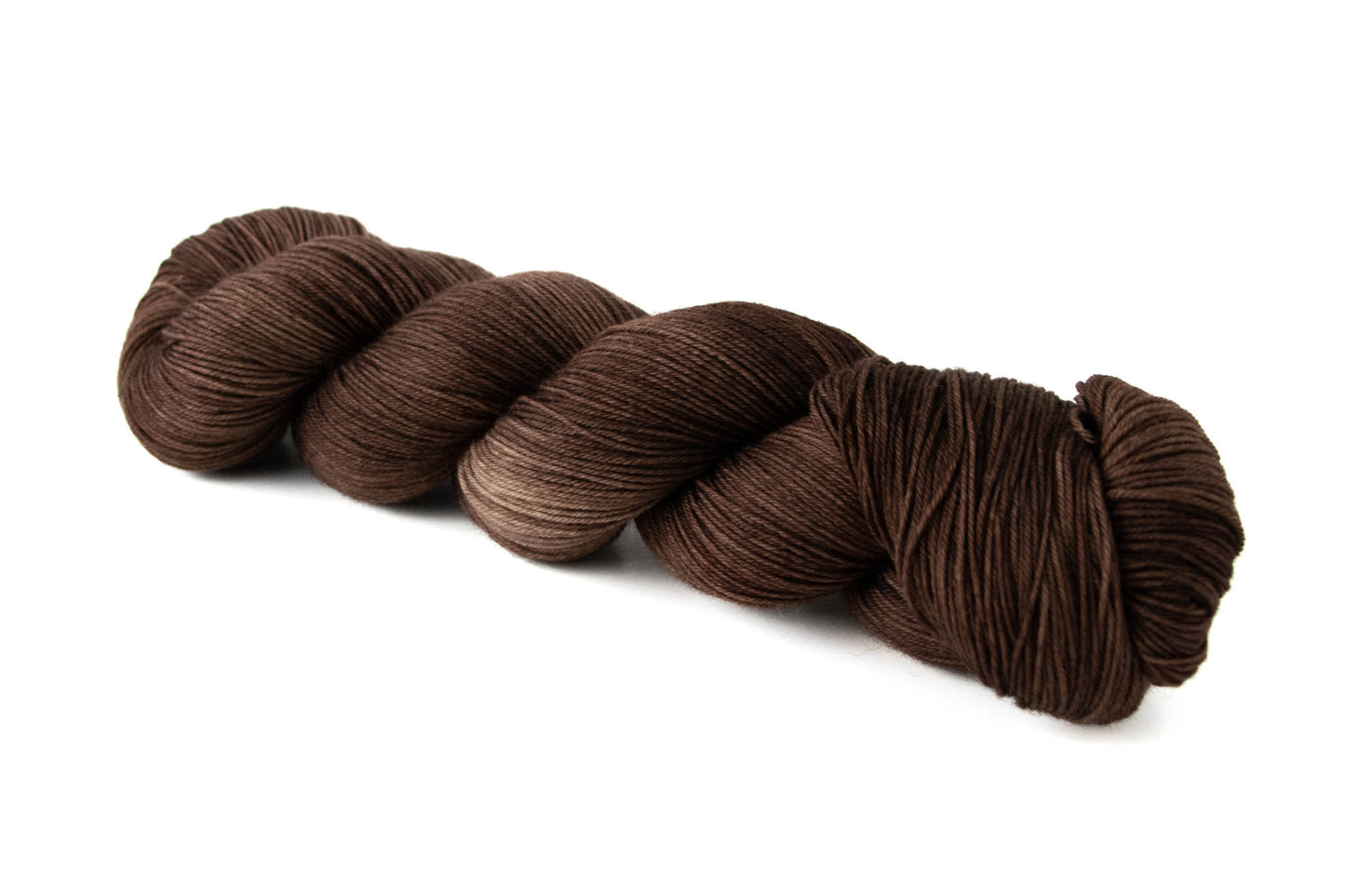 A skein of tonal chocolate brown hand-dyed wool yarn.