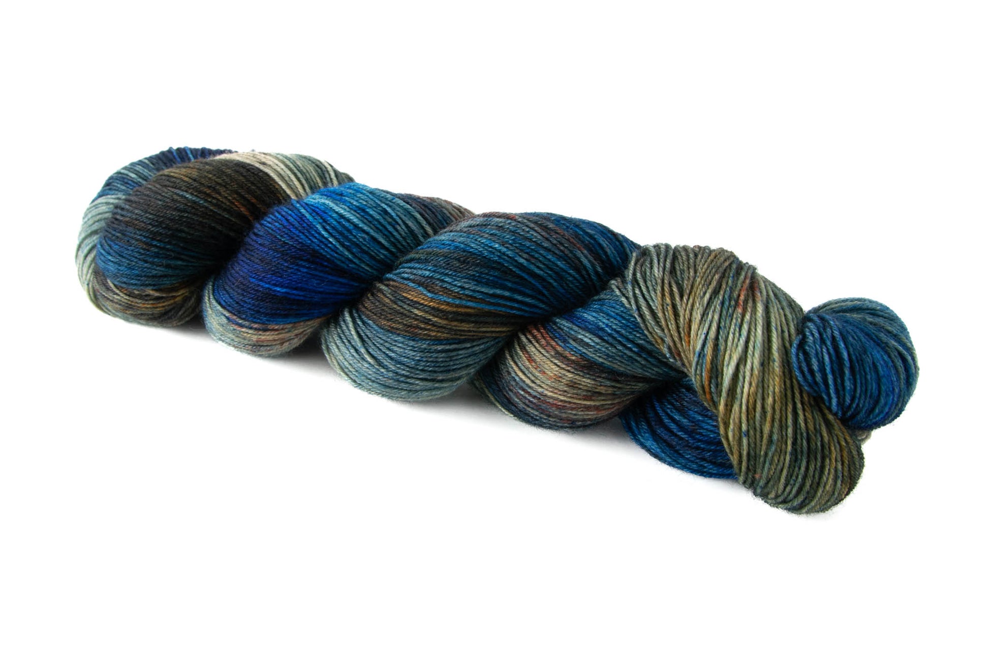 A skein of deep blue hand-dyed wool yarn with sections of dark brown and lighter tan sections with orange speckles.
