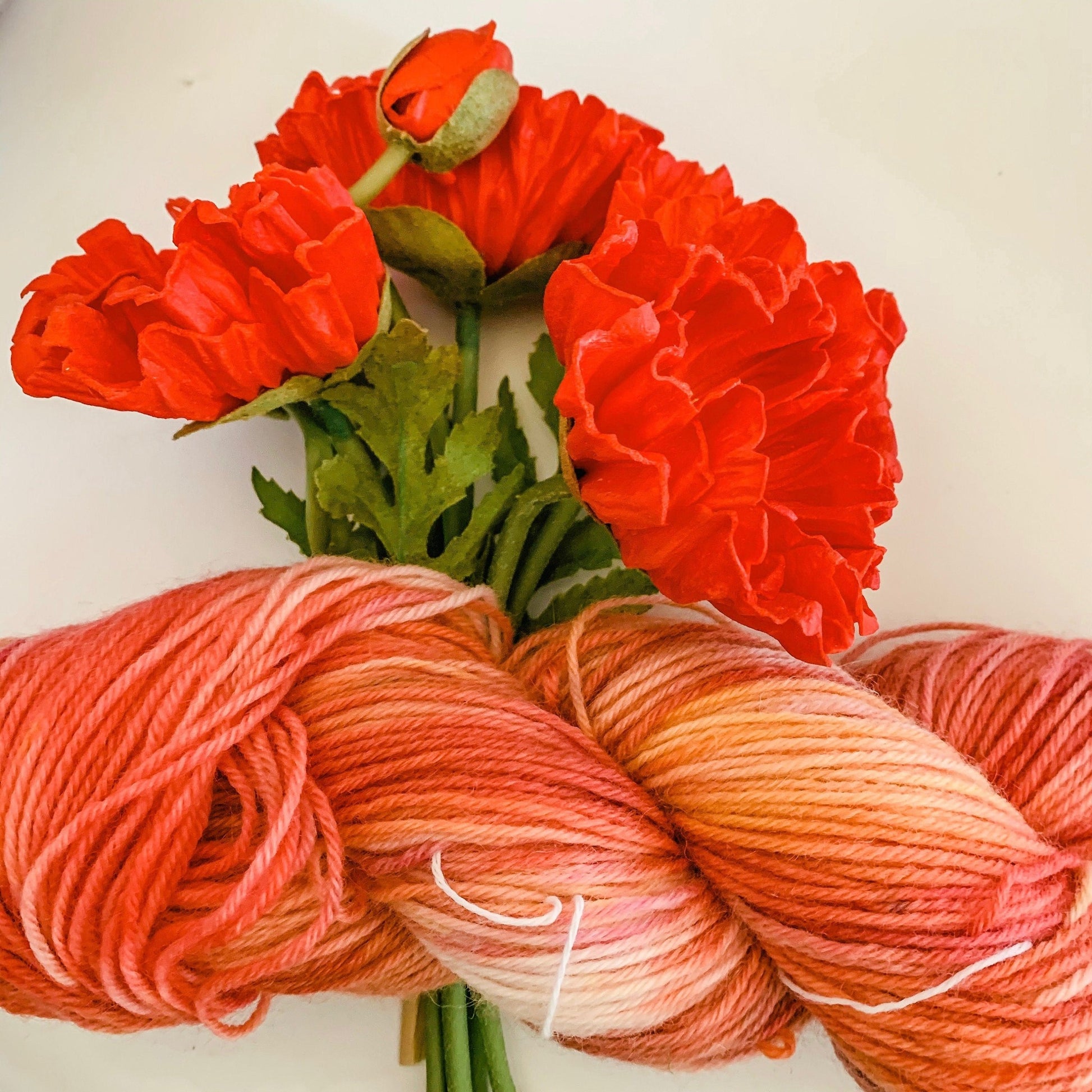 A close-up view of the Poppy colorway on a faux poppy flower.